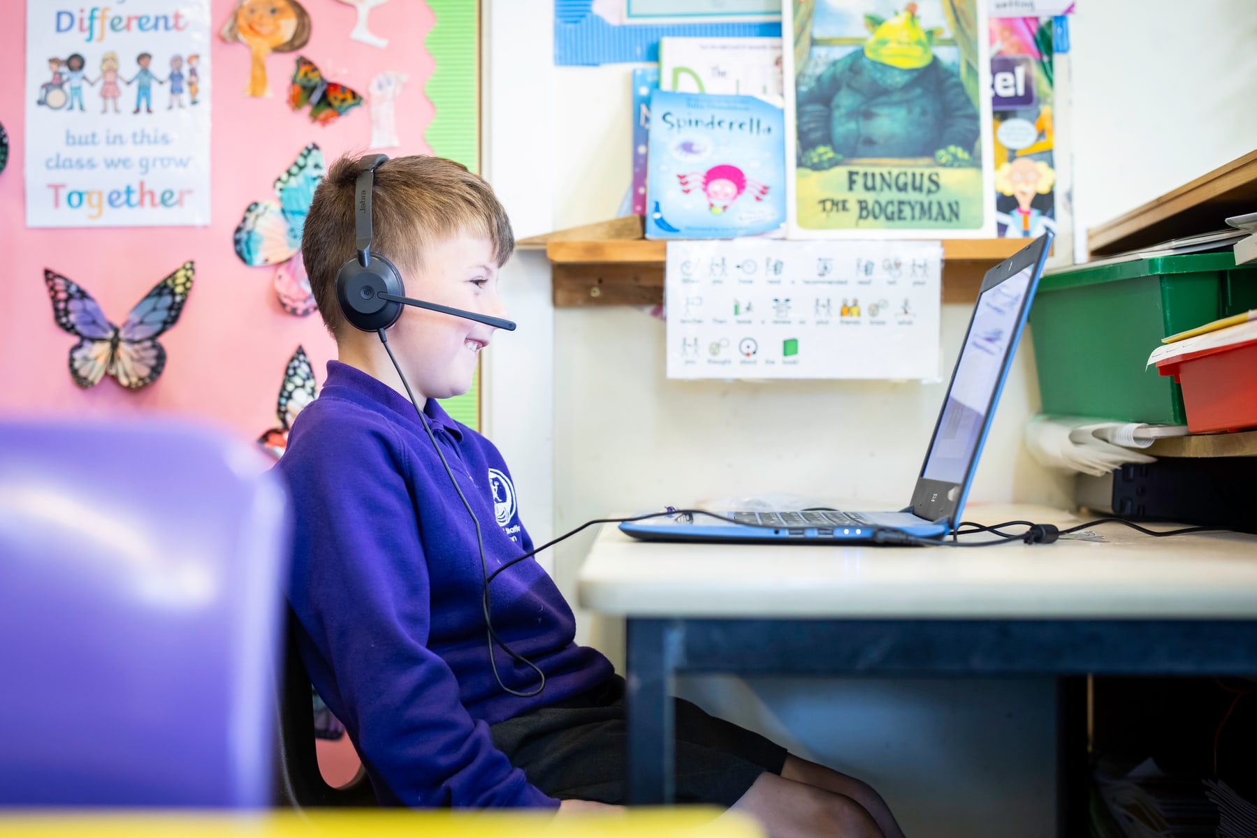 A child wearing a headset during a Chapter One online reading session